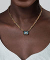 14K Yellow Gold Blue Topaz Emerald Cut Necklace With Flower Pattern J-Back and Black Enamel